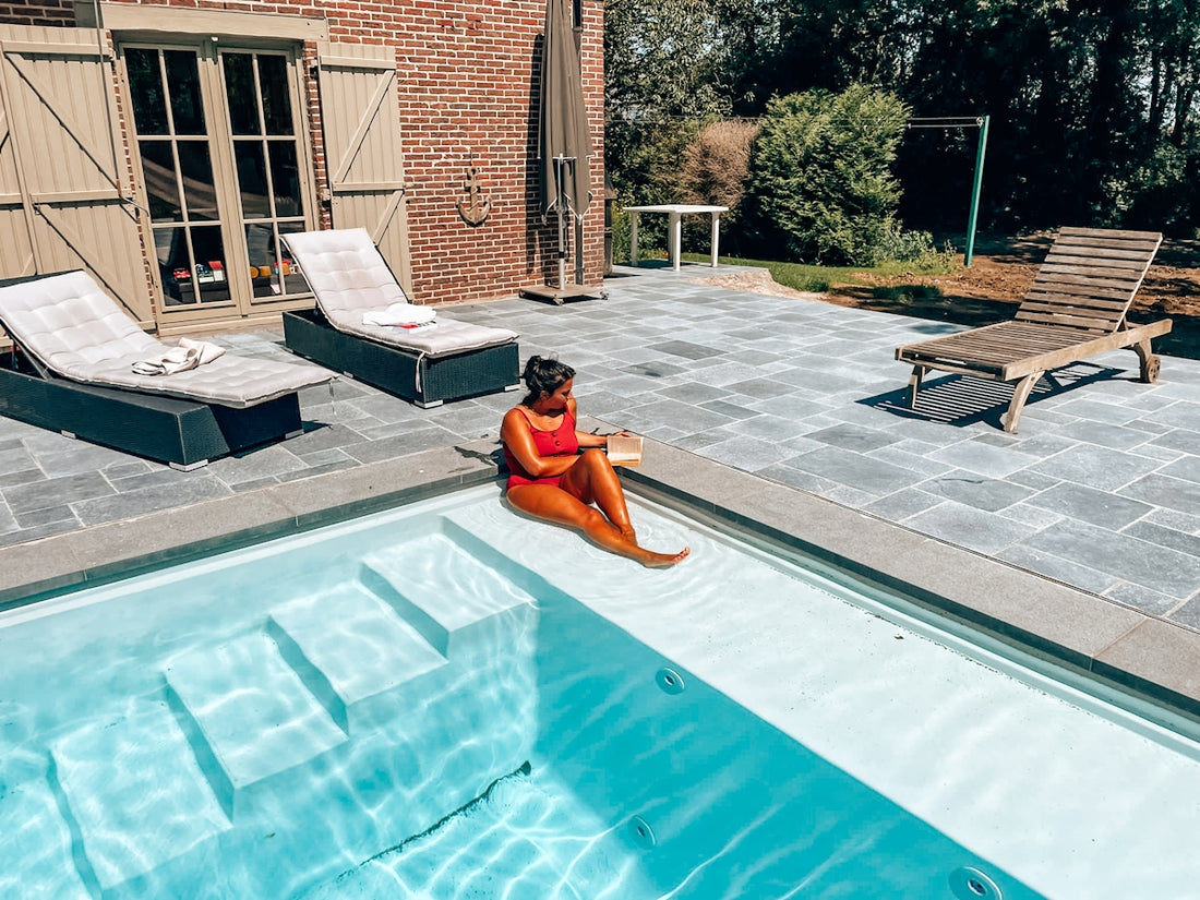 Woman relaxes by the pool on a sunny day.