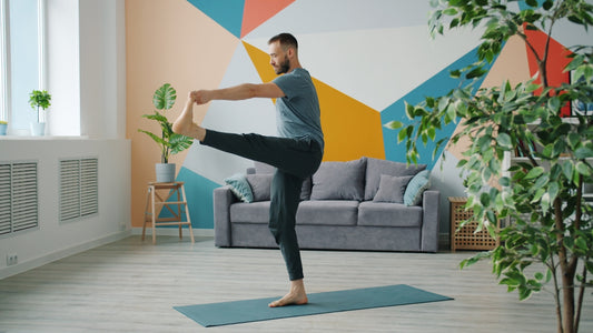 Man practicing yoga on a mat in a colorful room.