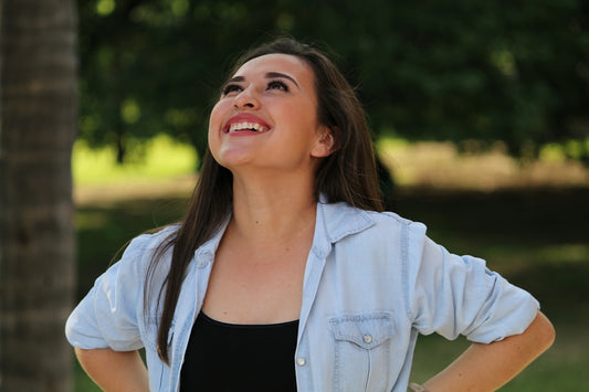 A young woman smiling and looking up outdoors