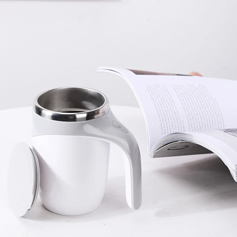 White ceramic cup with silver interior on a white surface